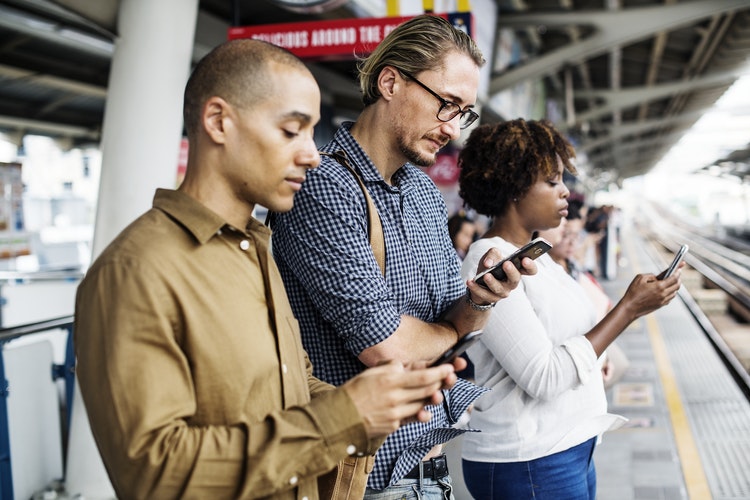 Millennials using mobile devices to interact with media.